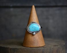 MeShe brings a Kingman Turquoise stacking ring, featuring a hand-cut free-form turquoise cabochon. Hand bezel set with a sterling border and ball accent. Each band is hand recycled and rolled from sterling silver to a half-round ring shank. Comfortable for everyday wear, hand-polished to a mirror high shine. This ring is ready to ship in size 8.75. Lead Times Ready to Ship 1-3 business days (M-F) Details Kingman Turquoise Fine Silver Bezel Recycled Sterling Silver Dimensions: Turquoise: 11x14mm Wild Jewelry, Split Shank Engagement Rings, Ring Shank, Kingman Turquoise, Round Rings, Titanium Rings, Classic Jewelry, Womens Wedding Bands, A Mirror