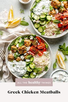 two white bowls filled with greek chicken meatballs and cucumber salad next to lemon wedges