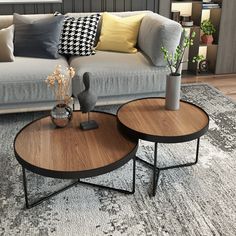 two tables sitting on top of a rug in front of a couch