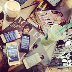 a table topped with books and cell phones