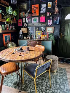 a table and chairs in a room with pictures on the wall