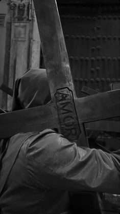 black and white photograph of a person holding a cross