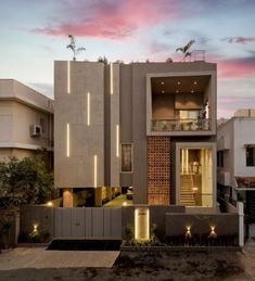 an exterior view of a modern house with lights on the side and stairs leading up to it