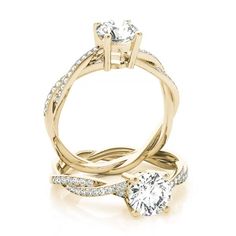 an engagement ring with two diamonds on top and the band around it, set in yellow gold