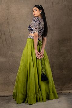 Pista green lehenga in organza. Comes with blue embroidered blouse.
Component: 2
Pattern: Embroidery
Type Of Work: Zardozi, Coin, Mirror and Sequin
Neckline: Round
Sleeve Type: Half
Fabric: Organza and Crepe
Color: Green,Blue
Other Details: 
Cutwork detail on the hems
Closure: Back zip
Note: Belt worn by the model is not for sale
Occasion: Sangeet - Aza Fashions Green Tissue Silk Lehenga For Party, Green Organza Gown For Designer Wear, Green Lehenga For Reception, Green Organza Dress For Navratri, Designer Green Organza Lehenga, Designer Organza Lehenga In Green, Green Choli With Cutdana For Reception, Green Chanderi Dress For Reception, Green Organza Choli With Intricate Embroidery