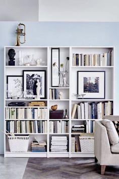 a white bookcase filled with lots of books