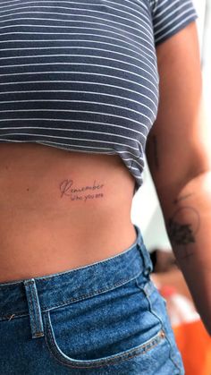 a woman with a small tattoo on her stomach that says, remember where you are