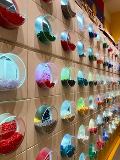 the wall is filled with many different colored bowls