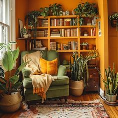 a living room filled with lots of plants and bookshelves next to a window