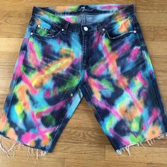 a pair of shorts with multicolored tie - dye on the front and back