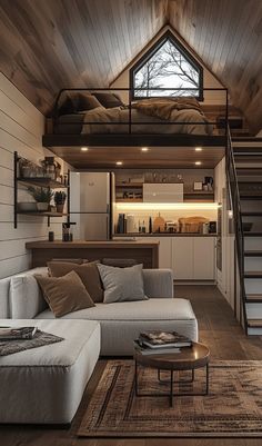 a living room filled with furniture next to a stair case in a loft style home