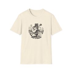 SHop into laid-back vibes with our 'Retro Grooves Frog Guitar Tee.' This shirt features a cool frog jamming on a guitar, bringing a playful and retro feel to your wardrobe. The slogan 'Just Froggin'' adds a whimsical touch, reminiscent of 'just chillin',' making it a fun and stylish statement piece. Crafted for those who appreciate a blend of nostalgia and humor, this tee is perfect for music lovers, frog enthusiasts, or anyone looking to add a touch of retro charm to their casual wear. Let the Frog On Skateboard T-shirt, Frog Guitar, Frog Playing Guitar, Cool Frog, Catchy Slogans, Style Shirt, Playing Guitar, Relaxed Style, Style Retro