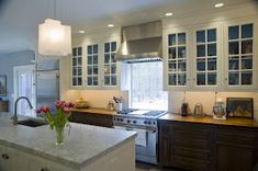 a kitchen with an oven, stove and sink in it's center island area