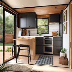 a kitchen with an island and stools next to the counter top in front of a sliding glass door