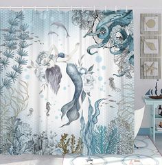 the shower curtain is decorated with an image of mermaids and sea creatures in blue tones