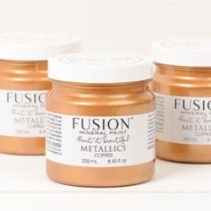 three jars of metallic paint sitting next to each other on a white surface with the words fuson written in it