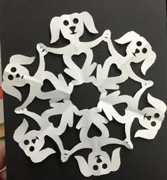 someone is holding up a card with cut out animals and skulls in the shape of a snowflake