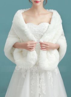 a woman in a white dress and fur coat