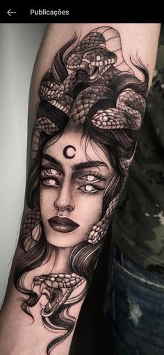 a woman's arm with a snake on it and her face painted in black ink