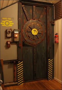 an old door with a clock on it in a room that has wood floors and walls