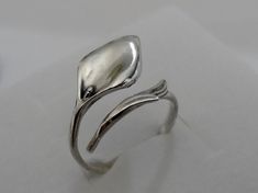 Calla Lily ring made of Sterling Silver .925 Modern twist look. Adjustable design. Weight - approx. 2 - 3 gr. The item is stamped/marked .925! 100% guaranteed quality. Images are real and not processed with Photoshop. All of this can be seen in the photos. NOTE: Due to the difference device/monitors being used, pictures may not reflect the actual colour of the item. Copyright infringement is prohibited! Work only in sterling silver, not in chrome plated pewter. Do not hesitate to contact us if y Elegant Adjustable Sterling Silver Flower Ring, Adjustable Open Flower Ring In White Gold, Adjustable White Gold Flower Open Ring, Adjustable White Gold Open Flower Ring, Elegant Adjustable Sterling Silver Bypass Ring, Calla Lily Jewelry, Lily Ring, Stackable Jewelry, Animal Rings