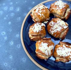 a blue plate topped with pastries covered in coconut