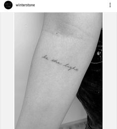 a black and white photo of a woman's arm with the word love on it