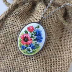 Embroidered necklace with dandelion, red poppy, and blue cornflower is a wonderful gift for women for any occasion. Flower jewelry pendant great gift for mother's birthday from daughter or son. Pendant with embroidery wildflower perfect for every day and for a special occasion. This pendant is made in the technique of micro-embroidery petit point on cotton canvas with cotton threads.  The size of each stitch is less than 1 mm. MATERIALS: The color of the base and chain-silver (not silver plated) Micro Embroidery, Petit Point Embroidery, Embroidered Necklace, Blue Cornflower, Mother Birthday, Necklace Flower, Red Poppy, Mother Birthday Gifts, Chain Silver