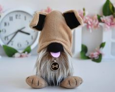 a small stuffed dog sitting next to a clock