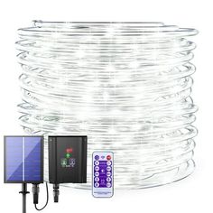 an image of a solar powered light with remotes and wires on the ground next to it