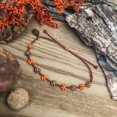 "I was drawn to these sparkly topaz beads, which reminded me of tiger lilies. The orange variants of these flowers really stand out to me during the summer. I also recently discovered \"prairie tiger lilies\" - the newest wildflower I'll be trying to find on hikes! This color scheme will be perfect to follow stacks into autumn and matches perfectly with the classic beaded version, found here: https://colorsoftheprairie.etsy.com/listing/1513762563  This listing is for 1 adjustable seed bead brace Adjustable Orange Bohemian Friendship Bracelet, Hand-strung Bohemian Orange Friendship Bracelets, Orange Flower Jewelry For Beach, Orange Flower-shaped Jewelry For Beach, Orange Bohemian Jewelry For Friendship, Adjustable Hand-strung Flower Jewelry, Orange Flower-shaped Beach Jewelry, Orange Bohemian Friendship Bracelets As Gifts, Adjustable Orange Bohemian Jewelry