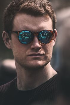 a man wearing sunglasses looking at the camera