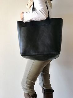 "Oversized leather bag, made with the highest quality veg tanned leather. Its clean, design and large size makes this beautiful bag a versatile bag for your daily day or traveling, allowing to carrying lots of things. Features: - Highest quality Full Grain Veg Tanned leather - Aprox Measures: 14-17.5 in wide (35-45 cm) (bottom and aprox top width) - easily fits a 15\" laptop 14 in high (36 cm) 6 in deep (15 cm) Big outside pocket (14\"x10\") or (36x25 cm): This pocket is big enough for a 13\" la Everyday Satchel Weekender Bag With Pockets, Everyday Shoulder Weekender Bag With Pockets, Rectangular Weekender Bag With Pockets For Everyday Use, On-the-go Tote Bag With Silt Pocket, Everyday Use Tote Shoulder Bag With Flat Pocket, Rectangular Shoulder Bag With Silt Pocket For Everyday Use, Large Bags With Pockets, Large Everyday Bags With Pockets, Everyday Black Shoulder Bag With Silt Pocket