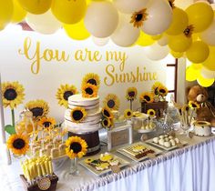 the dessert table is set up with sunflowers