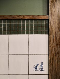 a tile wall with blue and white designs on it