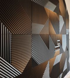 the wall is made up of many different shapes and sizes, including black and white stripes