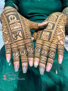 a woman's hands decorated with hennap