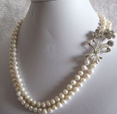 "Double strand pearl crystal brooch necklace, pearl necklace with brooch, diamond sparkle pearl necklace, wedding necklace, choker. Flower, Floral Motif Statement Wedding Bridal Necklace Art Deco Gatsby style! Crystal brooch 100% Natural Freshwater Pearl necklace Swarovski for Gatsby Wedding, Party or just for dressing up! This is a beautiful, classic, elegant necklace Elegant Bridal Wedding Jewelry 5-7mm Genuine Freshwater Cultured White Pearl Crystal Flower Statement Double 2 Row 18-19\" Stran Beaded Akoya Pearl Wedding Jewelry, Akoya Pearl Bridal Necklace For Wedding, Akoya Pearl Bridal Necklace In Pearl White For Wedding, Pearl White Akoya Pearl Bridal Necklace For Wedding, Single Strand Akoya Pearl Necklace For Weddings, Silver Akoya Pearl Necklace For Wedding, White Akoya Pearl Bridal Necklace For Wedding, Wedding Akoya Pearl Beaded Necklace, Wedding Beaded Akoya Pearl Necklace