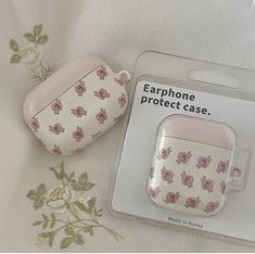 an earphone case with pink roses on it