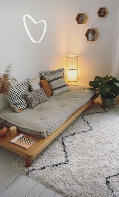 a living room with a couch, coffee table and potted plant on the floor