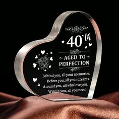 a heart shaped glass plaque with the words 40 years aged to perfection written on it