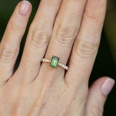 Give your style a sparkle with our Classic Prong Hidden Halo Sapphire solitaire with French Set diamond band. A 1.67ct emerald cut, opalescent green sapphire is at its center, measuring around 8x5mm. Its unique profile elevates your style and makes it easy to mix and match with similar bands. Crafted from recycled 18k yellow gold and decorated with delicate tapered, natural diamonds from 1.3mm to 2mm in size, this beauty will make a statement. Finish off your look with either a classic polished Gia Certified Emerald Cut Gemstone For Fine Jewelry, Gia Certified Emerald Cut Fine Jewelry Gemstones, Emerald-cut Tourmaline Wedding Jewelry, Emerald Cut Tourmaline Wedding Jewelry, Emerald Cut Diamond Fine Jewelry, Luxury Radiant Cut May Birthstone Jewelry, Elegant Emerald Cut Tourmaline Jewelry, Baguette Cut Tourmaline Jewelry For Weddings, Emerald Jewelry With Radiant Cut Accent Stones