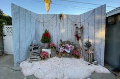 an outdoor area with flowers and decorations on the ground