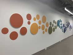 an office with white walls and colorful circles on the wall