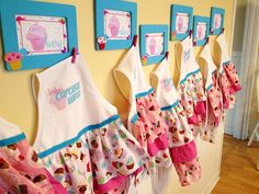 there are many aprons hanging on the wall