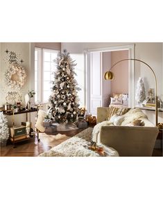 a living room filled with furniture and a christmas tree