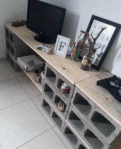 a tv sitting on top of a wooden shelf