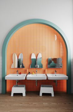 two sinks and mirrors in a bathroom with orange tiles