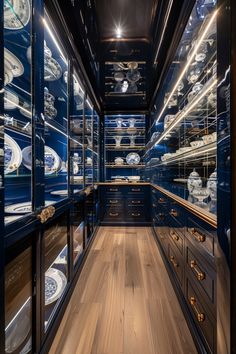 a room filled with lots of glass shelves and blue cabinets covered in plates on them