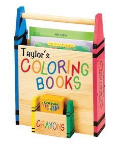 a wooden coloring book holder with crayons on the front and back sides, filled with books